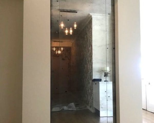 Antique mirror and glass hallway wall